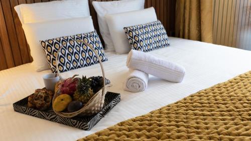 a hotel room with a tray of food on a bed at Maison Le Patio Jacuzzi in Saint-Denis