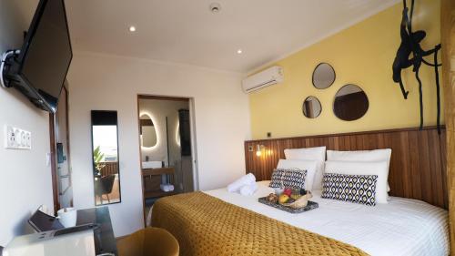 a bedroom with a large bed with a wooden headboard at Maison Le Patio Jacuzzi in Saint-Denis