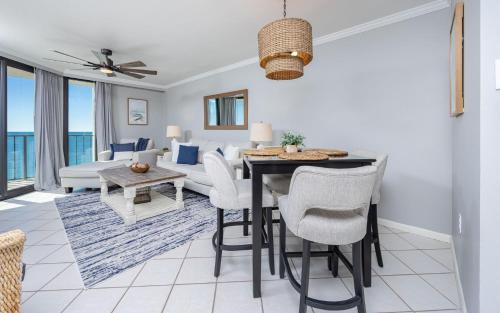 a living room with a dining room table and a couch at Phoenix III 3126 in Orange Beach