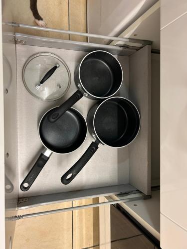 a bunch of pots and pans in a drawer at Sandcastle in Swansea