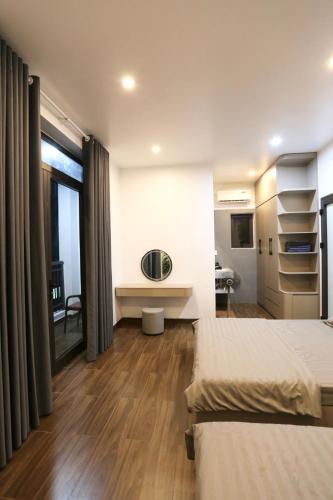 a hotel room with two beds and a window at VITA Homestay in Cat Ba