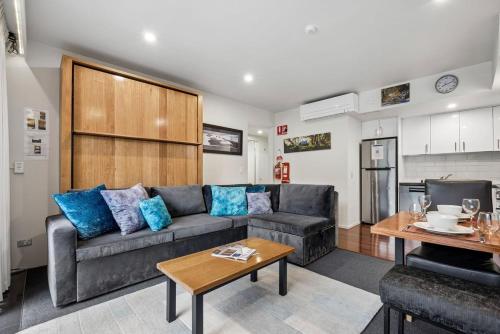 a living room with a couch and a table at Lantern 05 - Balcony in Thredbo