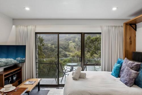 a bedroom with a bed and a large window at Lantern 05 - Balcony in Thredbo