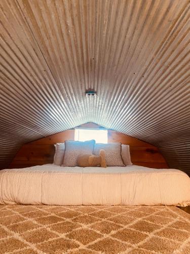 a large bed with a teddy bear on top of it at Cozy little Cabin in Van Buren