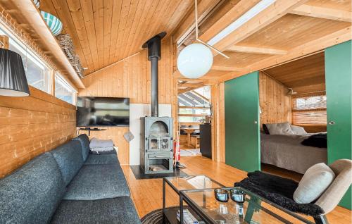 a living room with a blue couch and a fireplace at Amazing Home In Eggedal With Wifi in Eggedal