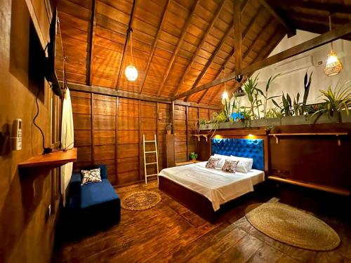 a bedroom with a bed in a wooden room at surf dom hotel & restaurants in Ahangama