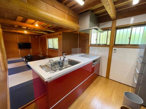 a kitchen with a sink in a room at レインボーマリン in Mihama