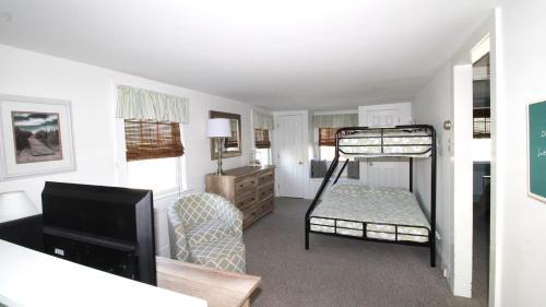 a living room with a bunk bed and a television at Gray Cottage On Windsor in Cape May