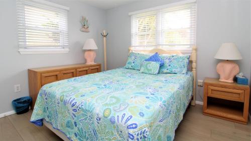 a bedroom with a bed with a blue and white comforter at 12 Mechanic St in West Cape May