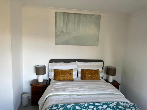 a bedroom with a bed with two brown pillows at Double Room with Garden View at Love & Peace Petts Wood in Orpington