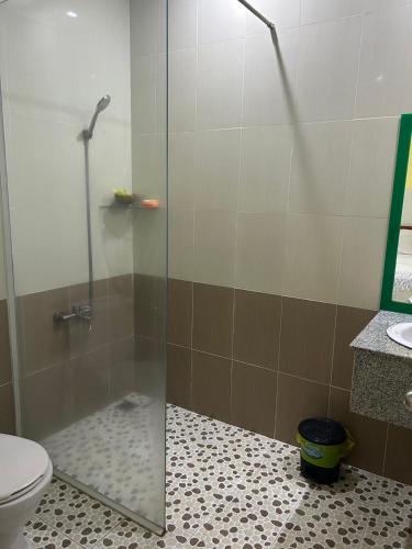 a bathroom with a glass shower with a toilet at Tan My Thien Hotel in Tây Ninh