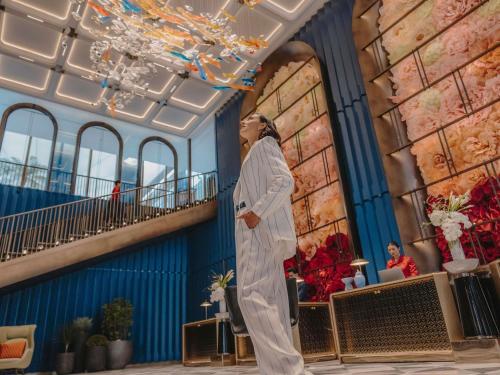 a woman standing in the lobby of a hotel at Fairmont Hanoi in Hanoi