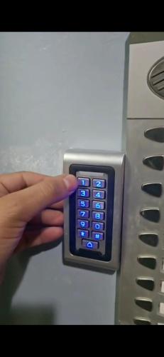 a person holding a remote control in a pay phone at AGADIR apparemment du LUX in Agadir