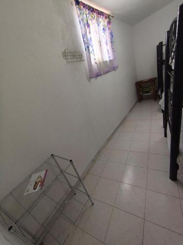 a room with a tile floor and a window at Bungalow privado con alberca Oaxtepec 14 personas in Oaxtepec