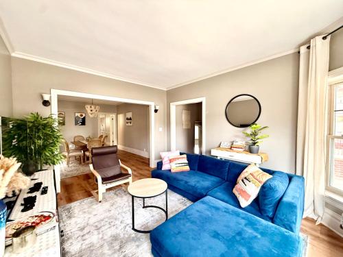 a living room with a blue couch and a table at Lovely vintage Oak Park 3bd 1ba perfectly located near public transit & Chicago in Oak Park