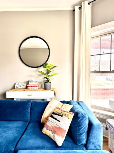 a blue couch in a living room with a mirror at Lovely vintage Oak Park 3bd 1ba perfectly located near public transit & Chicago in Oak Park