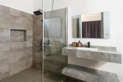 a bathroom with a sink and a shower at Rocky 36 in Grand-Baie