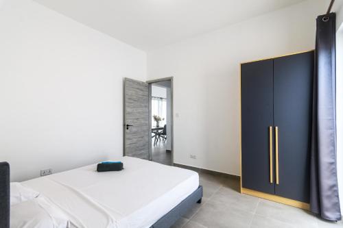a bedroom with a bed and a black cabinet at Rocky 36 in Grand-Baie