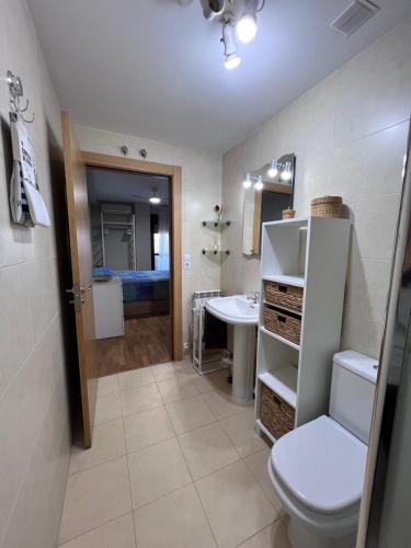 a bathroom with a toilet and a sink at Real 92 in Arguedas