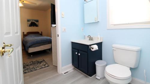 a bathroom with a toilet and a sink and a bed at 149 Emerald Avenue in West Cape May