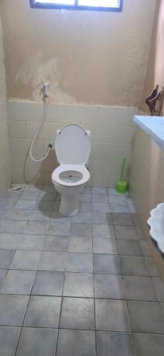 a bathroom with a white toilet and a sink at The Twende Villa on Beach in Paje