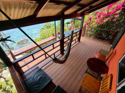 a porch with a hammock and a view of the water at Tao Thong Villa 2 in Ko Tao
