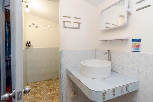 a bathroom with a sink and a mirror at Tao Thong Villa 2 in Ko Tao