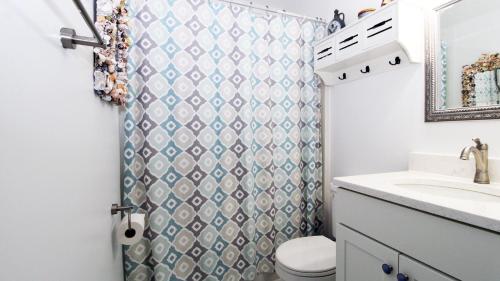 a bathroom with a sink and a toilet and a shower at The Roost Ii On Leaming in West Cape May