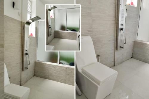 a bathroom with a toilet and a sink and a mirror at The white house in Kelaniya