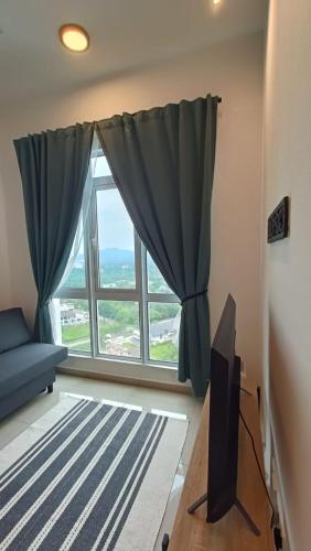 a living room with a large window and a tv at Adilili Mesahill Premier Homestay, Nilai near KLIA USIM AEON Mall Mesa Mall Aurelius Hospital in Nilai
