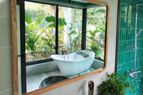 a bathroom with a sink and a mirror at KuTÓN ECOCAMP in Lương Sơn