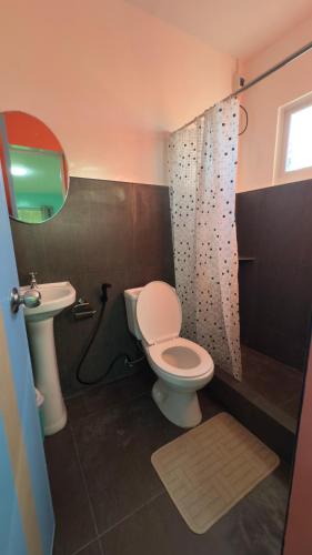a bathroom with a toilet and a sink at Bantayan Beachfront Seacamp Okoy Private House Operated by In Dai Aquasports and Beach Resort in Bantayan Island