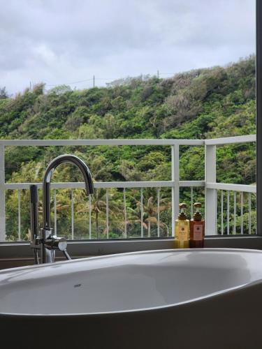 a kitchen sink with a view of a mountain at Tomoya in Chenggong