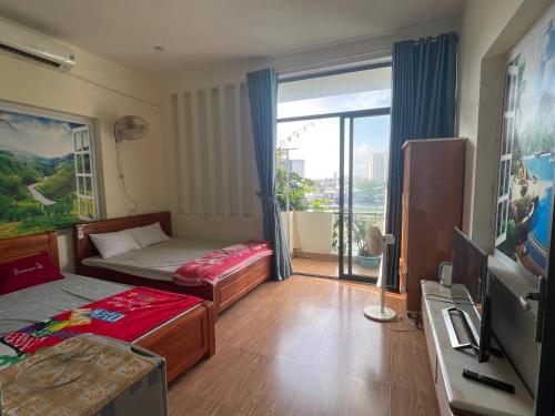 a bedroom with a bed and a tv and a window at 846B50 BÌNH GIÃ in Vung Tau