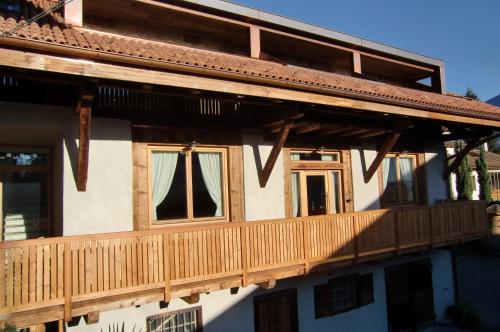 a house with a deck on the side of it at Neuprantl Apartments in Lana