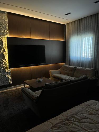 a living room with a couch and a tv at Safety house in Tabuk