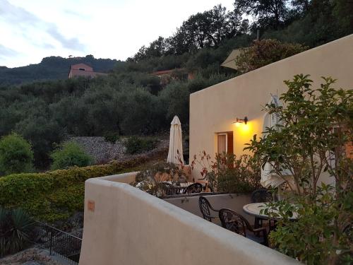 a balcony of a house with a table and chairs at Il Villaggio Di Giuele in Finale Ligure