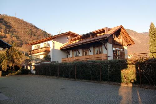 a house with a fence in front of it at Neuprantl Apartments in Lana