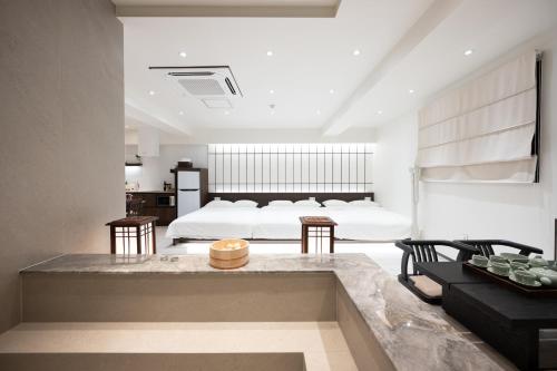 a bedroom with a bed and a living room at ryeoan seomyeon in Busan