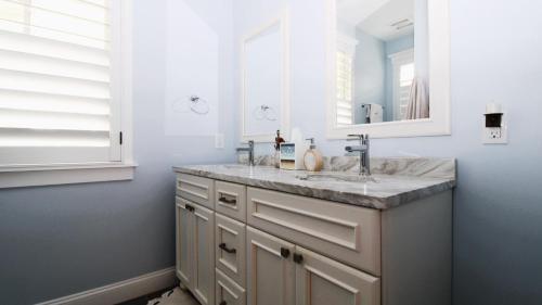 a bathroom with a sink and a mirror at Beach Croft in West Cape May