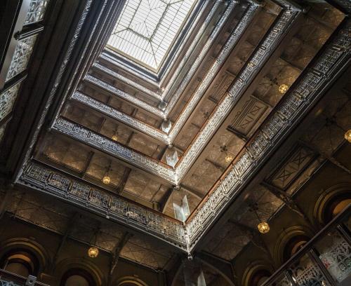 an ornate ceiling in a building at The Beekman, A Thompson Hotel, by Hyatt in New York