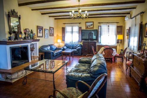 a living room with couches and a fireplace at Hospedium Hotel Val de Pinares in Bogarra