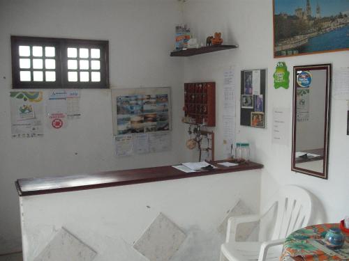 a bar in a room with a table and chairs at Pousada Chalé Suiço in Parnaíba