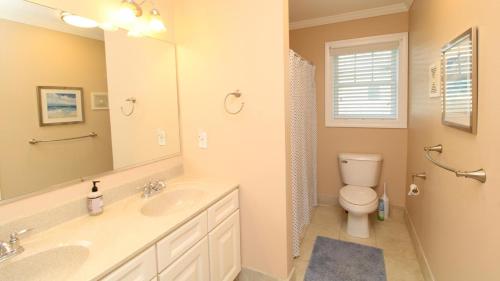 a bathroom with two sinks and a toilet and a mirror at 1036 Maryland Ave in Cape May