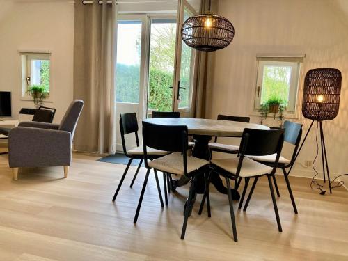 a dining room with a table and chairs at Olivia 6pers House with a private garden close to the National Park Lauwersmeer in Anjum