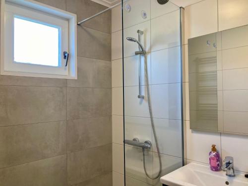 a bathroom with a shower and a sink at Olivia 6pers House with a private garden close to the National Park Lauwersmeer in Anjum