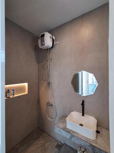 a bathroom with a white sink and a shower at Villa Luck Canggu Bali unit 8 in Canggu