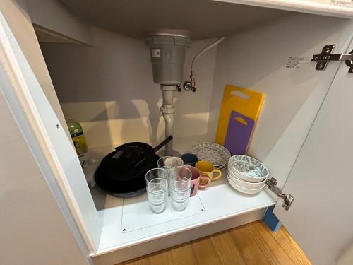a shelf with glasses and a mixer in a kitchen at Exsaison SETOUCHI in Sakaide