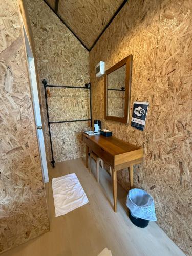 a small room with a wooden table and a mirror at Tavana Residence in Ban Na Bon