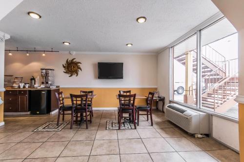 a room with a table and chairs and a balcony at Rodeway Inn in Hopkinsville